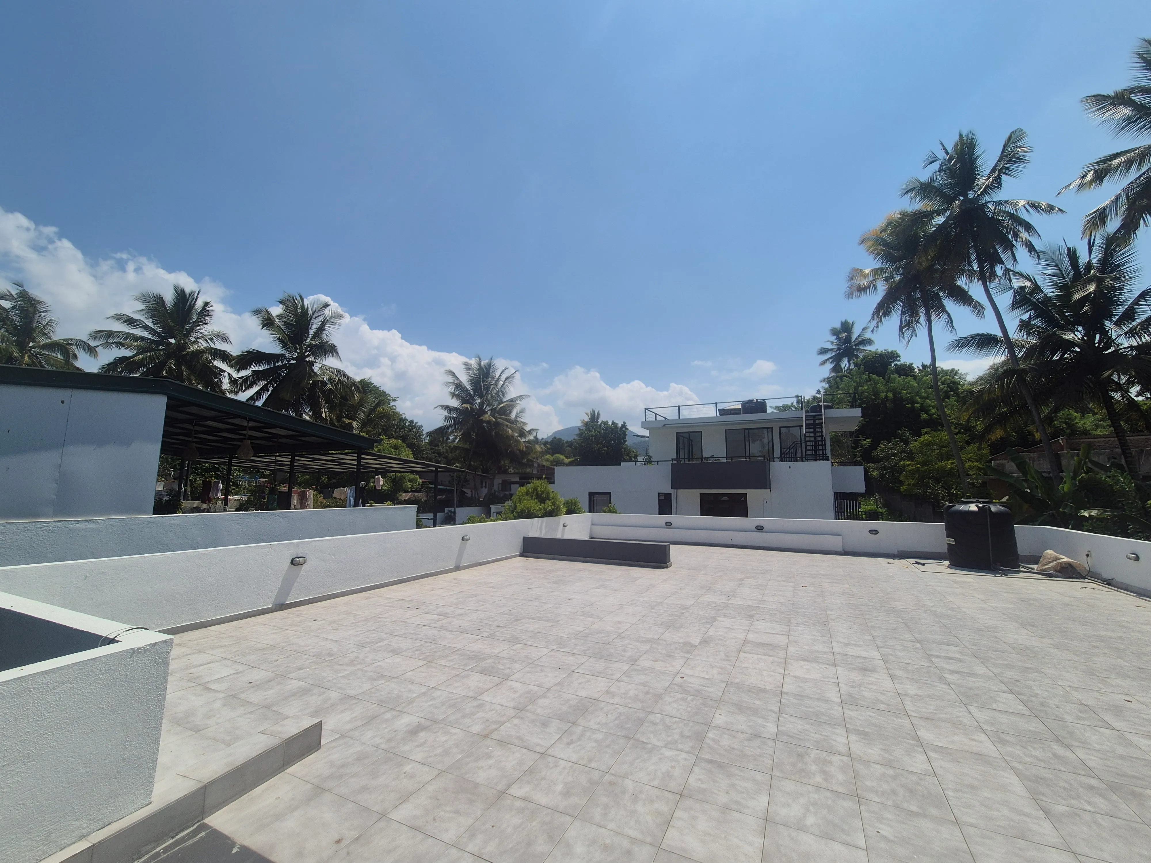 TenTwo rooftop relaxation area with scenic Kandy countryside views